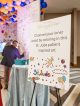 A poster on an easel reads, "Channel your inner artist by coloring in this St. Jude patient-inspired art."