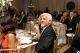 Three presenters smile and applaud onstage at St. Jude Evening with the Stars charity gala. 