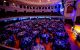 Aerial view of the Fitness for A Cure dinner gala at the Lowell Memorial Auditorium, showing tables filling the ground floor at the base of the stage. 