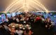 Guests enjoy dinner beneath an outdoor tent at the Justin Moore St. Jude Golf Classic.
