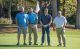St. Jude Peninsula Golf Tournament attendees pose on the green at Ford's Colony Country Club. 
