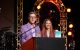 Kevin Rahm and his wife, Amy, stand at the podium at the 2024 Rahm Celebrity Golf Tournament. 