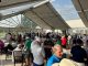 St. Jude Open attendees enjoy cocktails under an outdoor tent. 