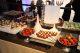 A table displays strawberries and confections. 