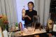 A cocktail server displays a bottle of Tito's Handmade Vodka. 