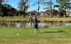A golfer swings a club at the St. Jude Houston Golf Classic. 