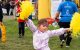 A child waves yellow pom-poms at the Northern California St. Jude Walk/Run.