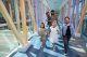 St. Jude patient Liliana with her family. walk through a glass corridor at St. Jude.