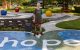 St. Jude patient Hunter stands on a colorful path that  has the word 