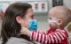 St. Jude patient Natlie is held by her mother in a hospital setting. 