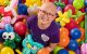 St. Jude patient Misheel is surrounded by colorful balloons and balloon  animals.