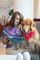 Woman reading with dog