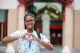 2022 St. Jude Leadership Society student forming a heart with her hands in front of the hospital. 