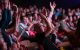 St. Jude Dream Chicago attendees cheer and raise their arms overhead. 