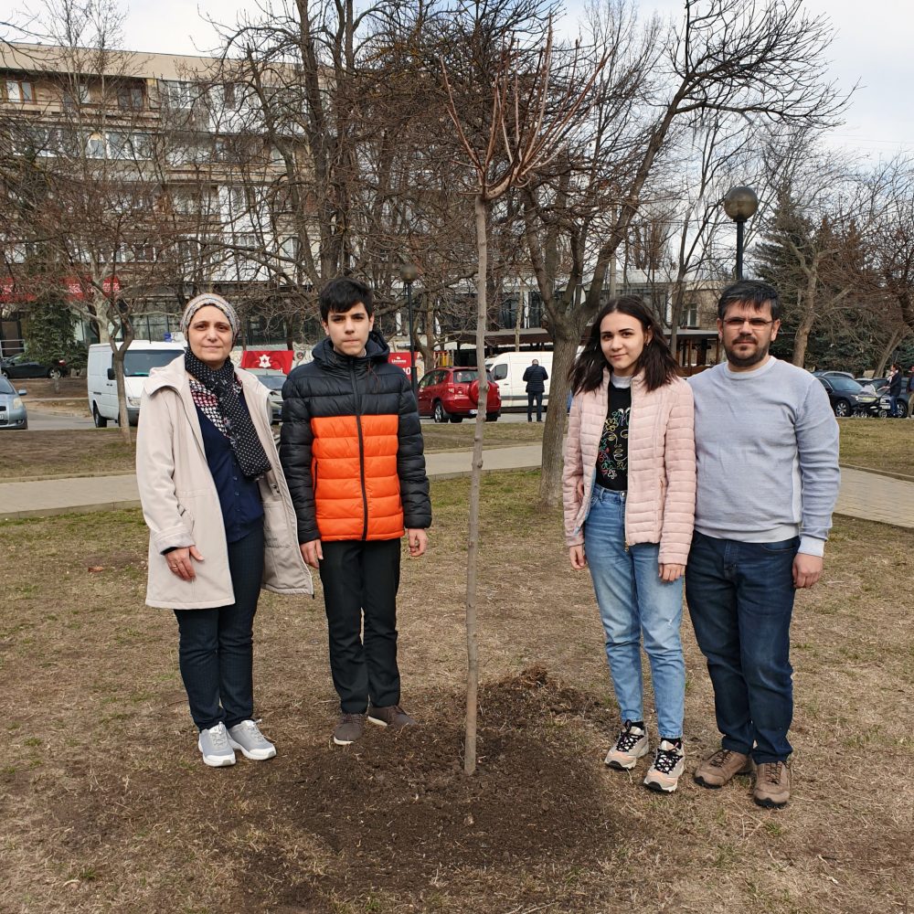 Gheorghe's family plants a tree in his memory.