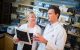 Charles Mullighan, M.D., M.B.B.S., M.D., member of the St. Jude Department of Pathology (Right), discusses research with Michelle Churchman, Ph.D. (left)