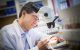 A male scientist uses equipment in the lab