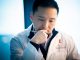 Researcher in lab coat reading.