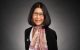Dr. Motomi Mori sits in front of a black background.