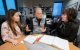 Three researchers discuss research findings at a round table.