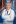 Researcher in lab coat smiling at camera.