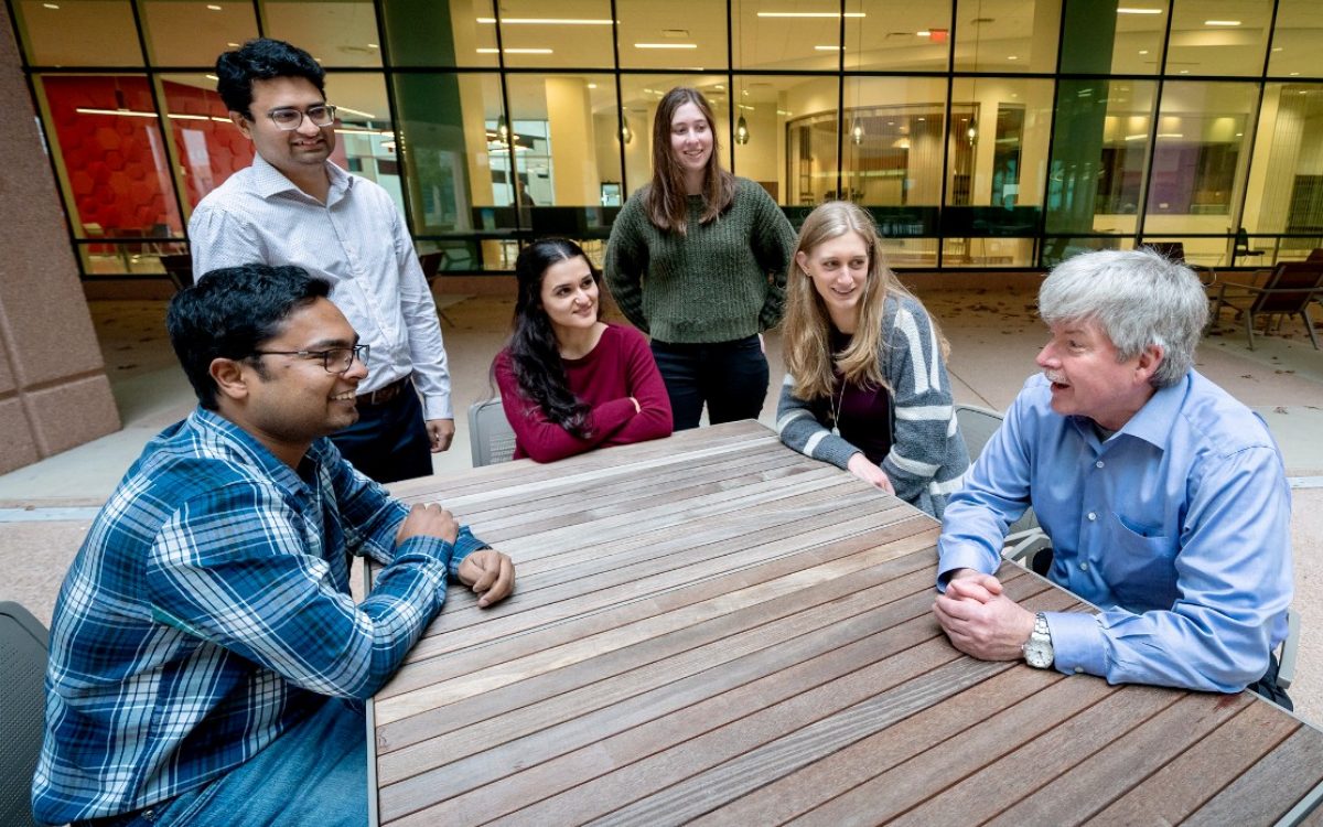 researchers sitting around an outdoor table