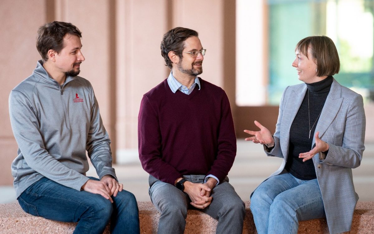 Three immunologists sitting outside having a conversation