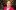 Researcher in red coat smiles at camera.