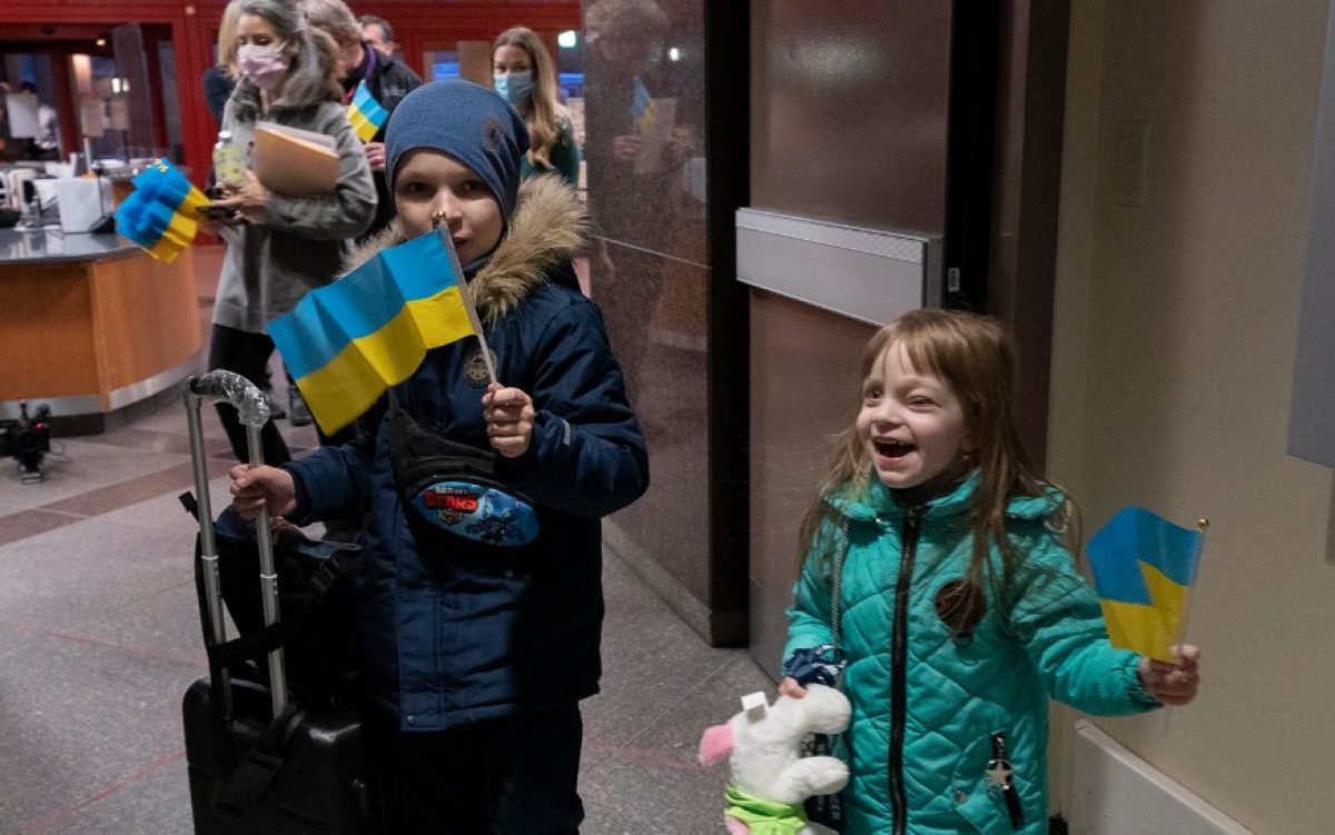 Children waving Ukrainian flag as they arrive at St. Jude