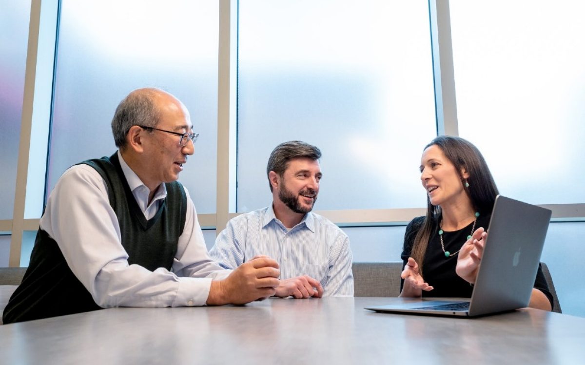 photo of 3 people sitting at a table