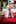 St. Jude patient wearing a pink dress and walking on a red carpet for the St. Jude Teen Formal.