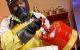 Environmental safety employee disposes of hazardous fluid.
