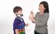 Child Life specialist using medical play to show how a feeding tube works.