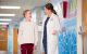 St. Jude physician talking to young female patient in hallway.