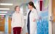 St. Jude physician Dr. Talleur talking to female patient in hallway.