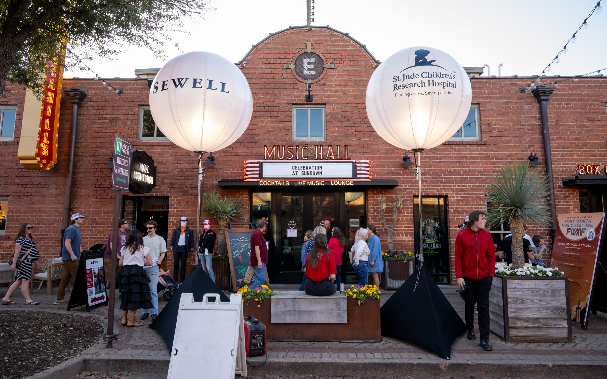 Attendees arrive to St. Jude Celebration at Sundown, where large paper latterns frame the entrance. 