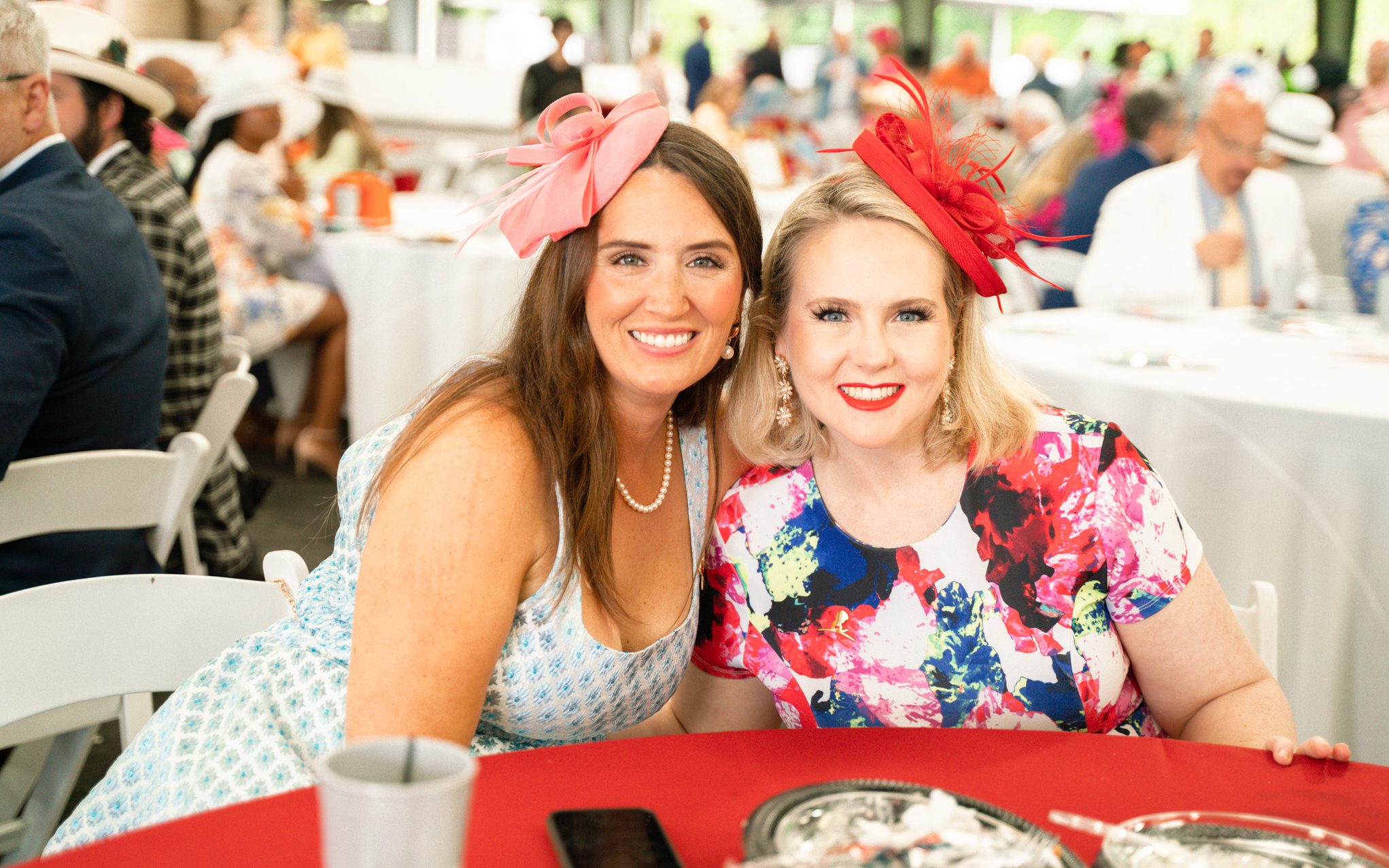 St. Jude Day at the Derby attendees smile in dresses and bonnets. 