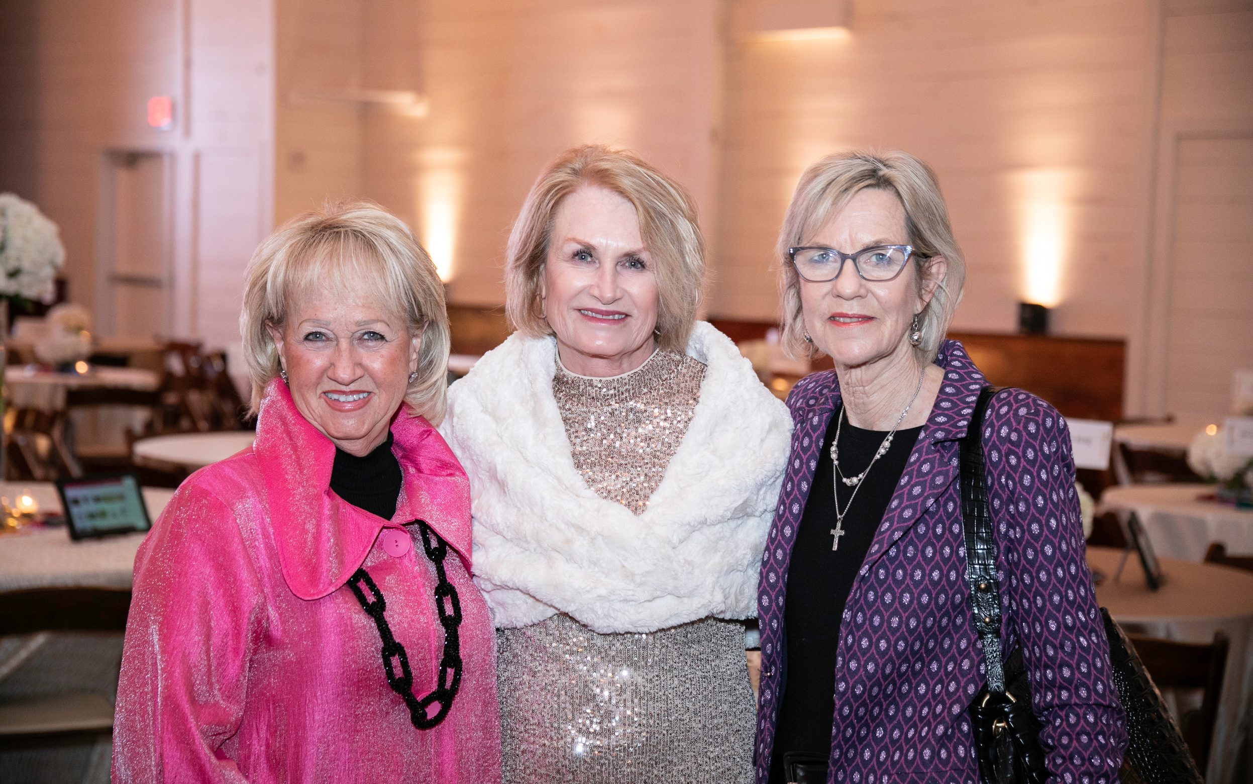 Taste of Oxford attendees smile with arms around each other's shoulders at the 2024 event in Oxford, Mississippi. 